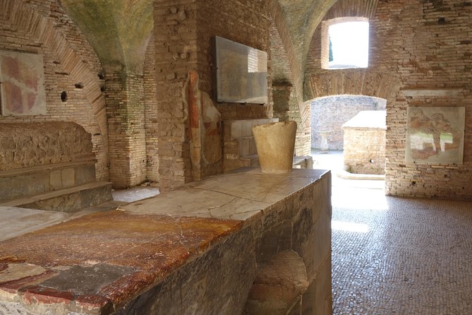 Ancient Ostia Antica Semi-Private Day Trip from Rome by Train with Guide - Baths of Neptune: mosaics, scale, and why it matters